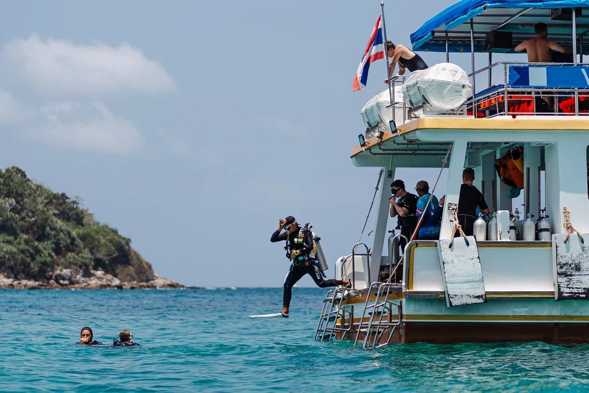 Scuba diver performing giant stride entry from Seafarer Divers Phuket dive boat